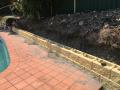 Floraville Garden Wall : Demolition of old wall. Preliminary Excavations and levels. Supply, construct, drain and backfill new Heron block wall. Supply and install organic soil, mulch and decorative gravels